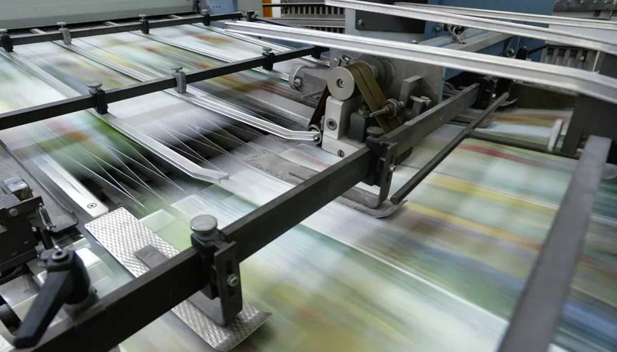 High-speed printing press in action, demonstrating our expertise in card technology, capable of producing various card materials including the latest eco-friendly wood and paper cards.