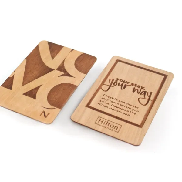 Eco-friendly wooden hotel key cards from Hilton, featuring custom engravings for a unique, sustainable guest experience.